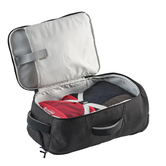 Interior of black Caribee backpack with red packing cube and shoe compartment
