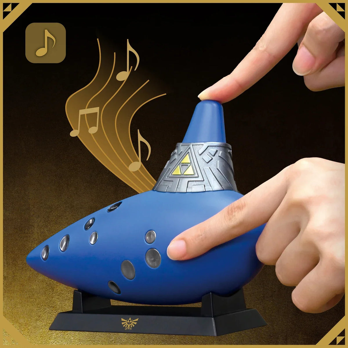 Hands playing Hori electric ocarina controller with illustrated musical notes