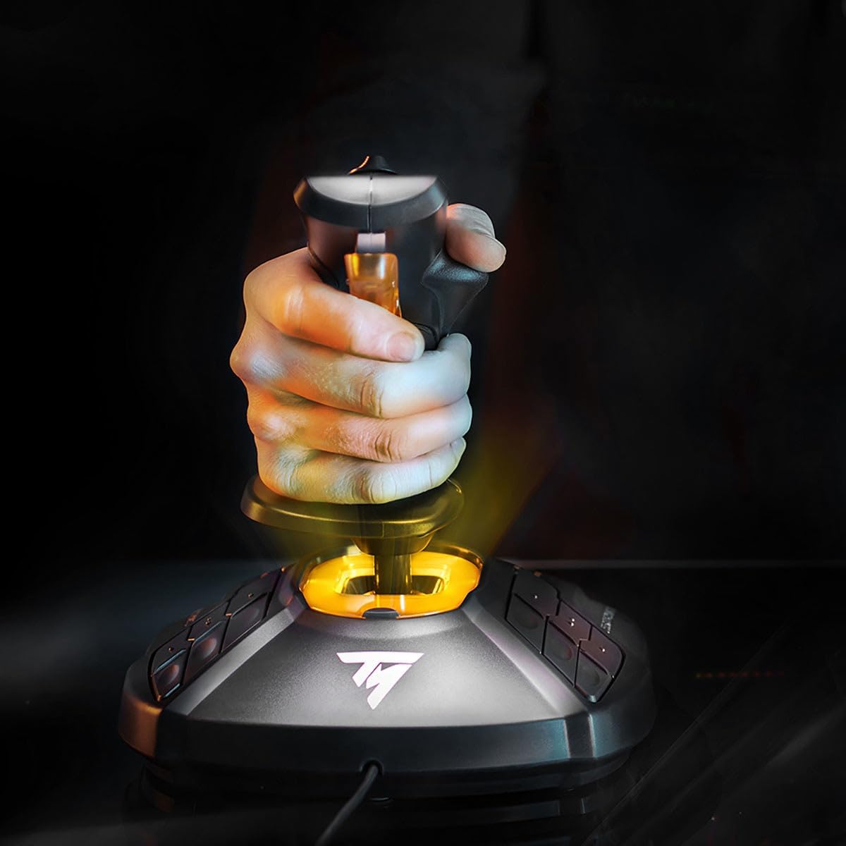 Hand gripping Thrustmaster T.16000M FCS joystick highlighting glowing orange base sensor