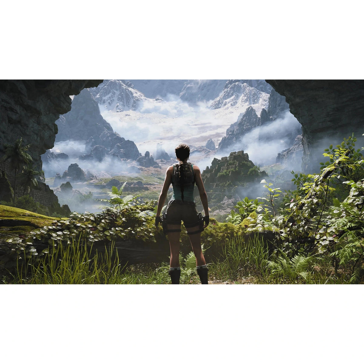 Lara Croft at cave edge overlooking snow-capped mountains and green valleys