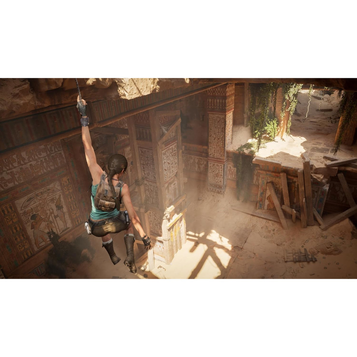 Lara Croft swinging on rope in ancient ruin gameplay screenshot from Tomb Raider Legacy of Atlantis